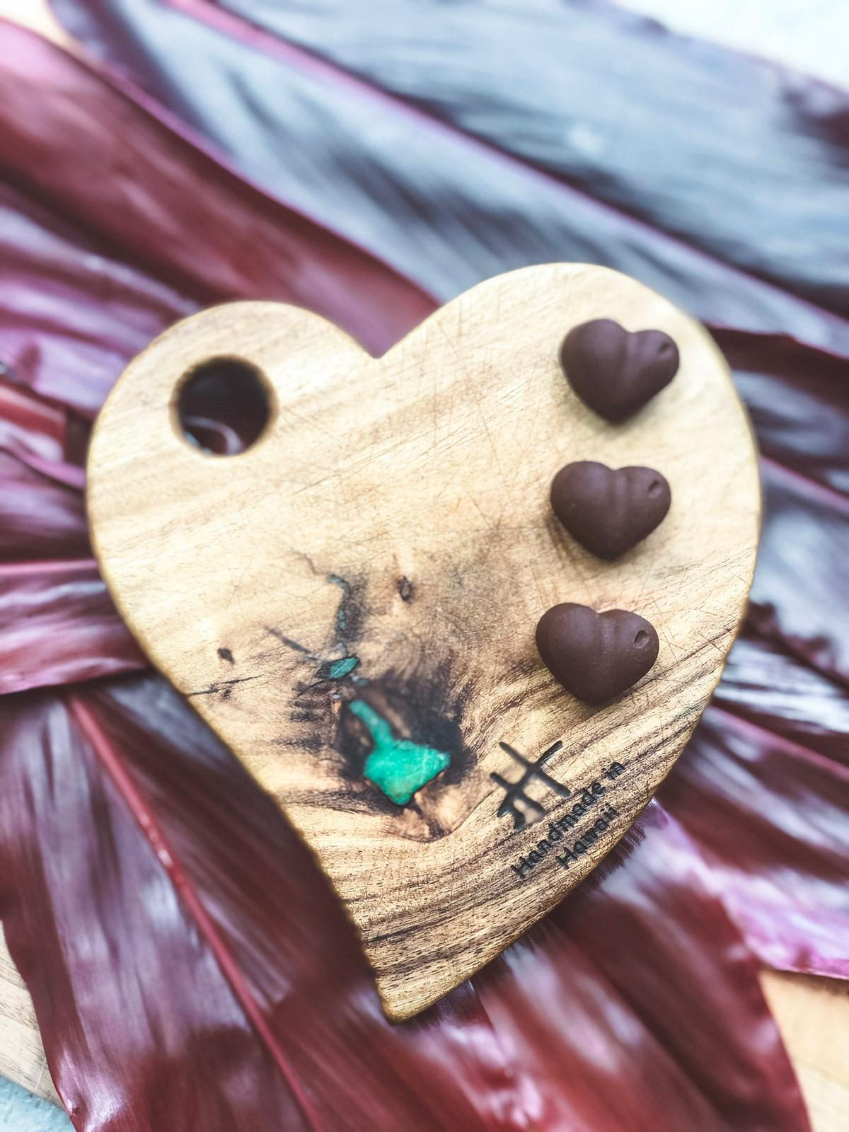 A finished custom board: deep grain, live edge, chrysocolla inlay.