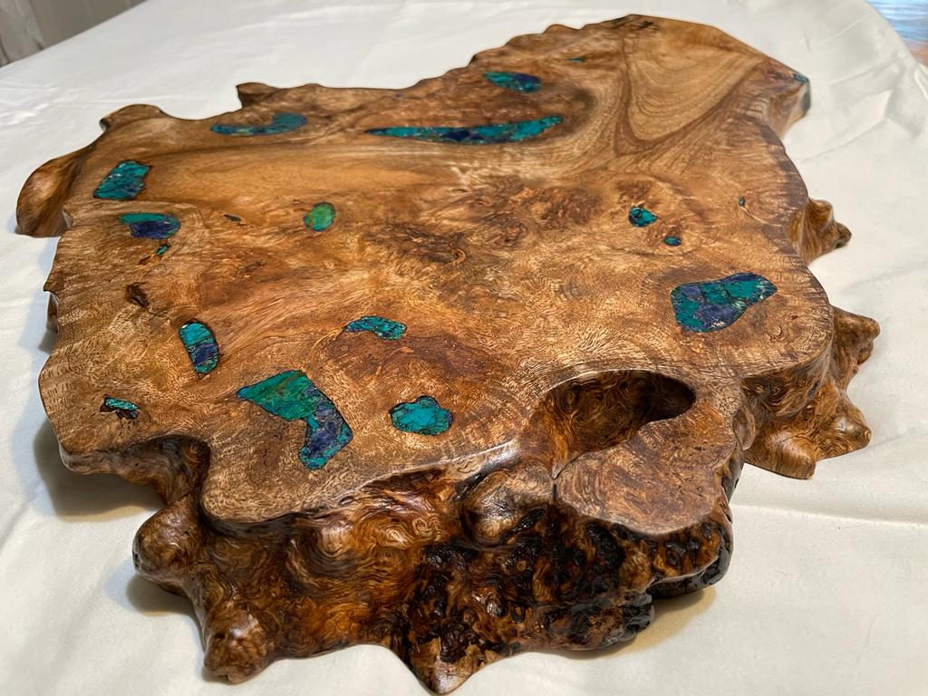 Burl serving board with brilliant chrysocolla stone inlay.
